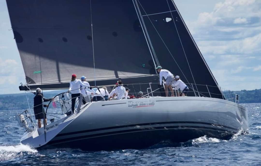 Sailboat with crew on open water