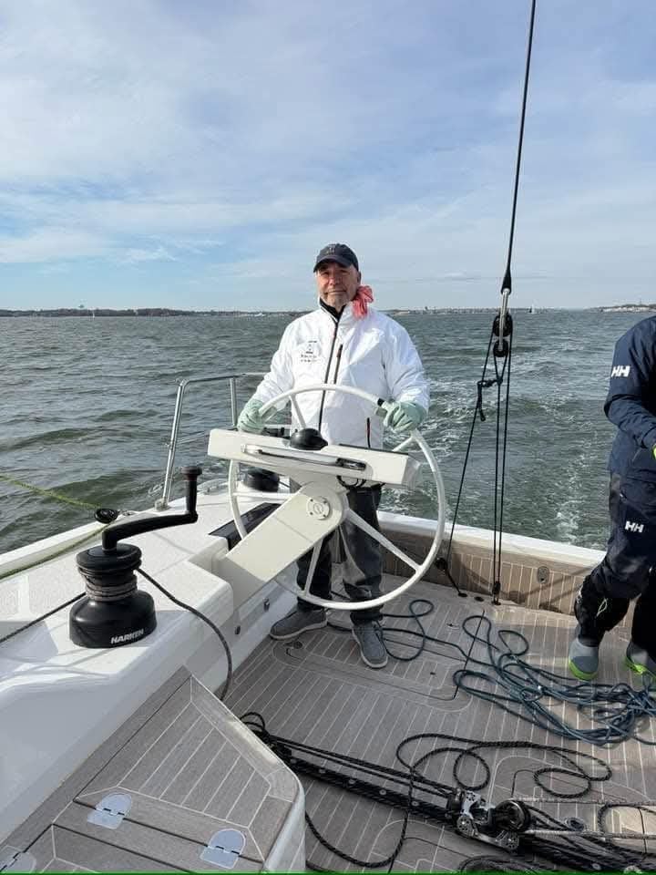 Person steering a sailboat
