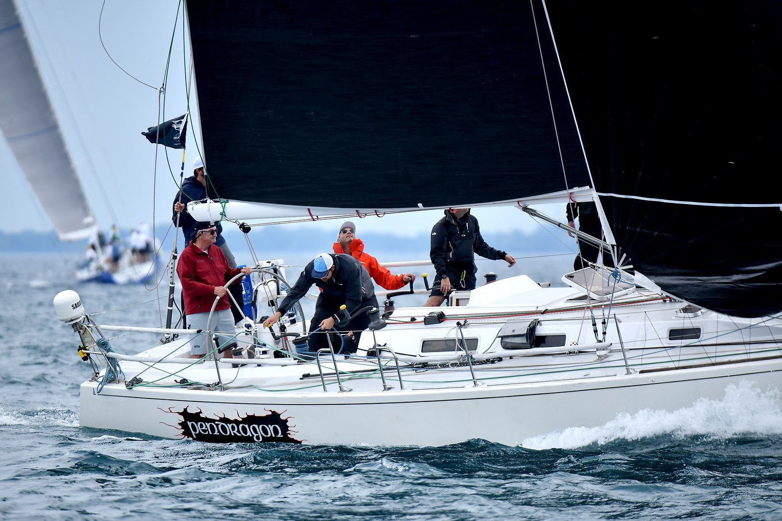Sailboat named Pendragon with crew on deck