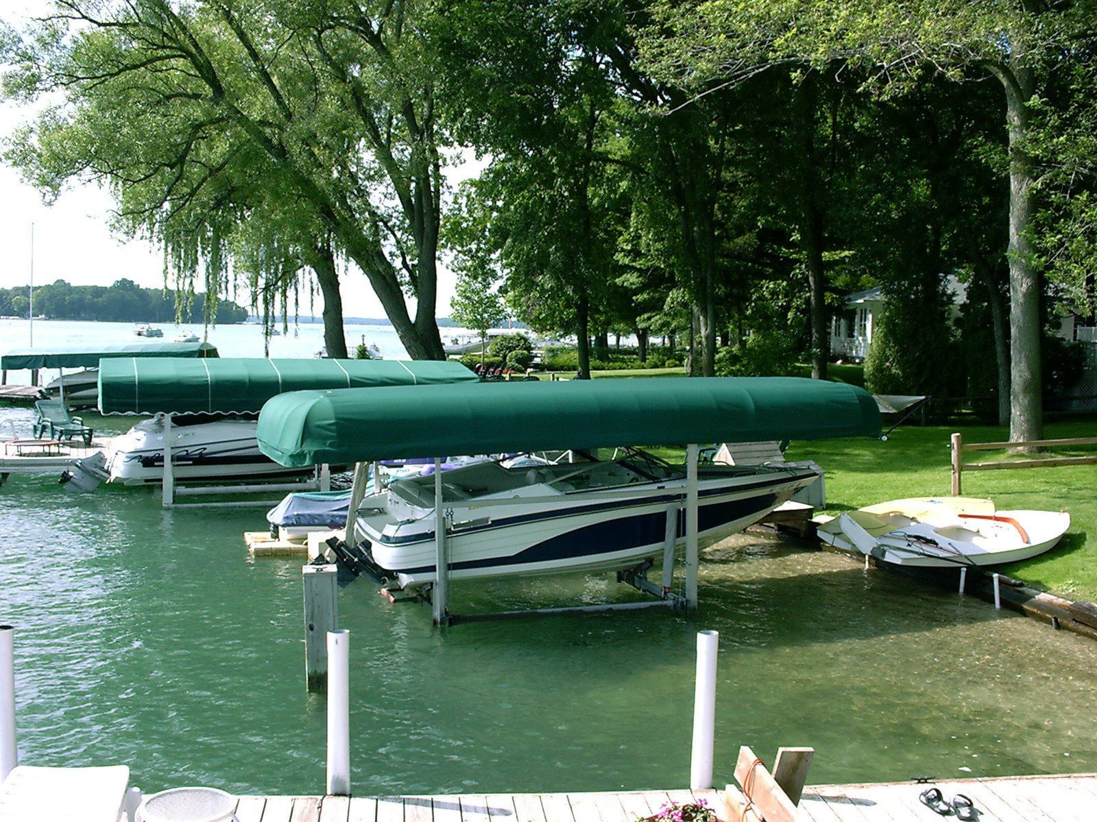 Boat dock with motorboats and covers on a lake