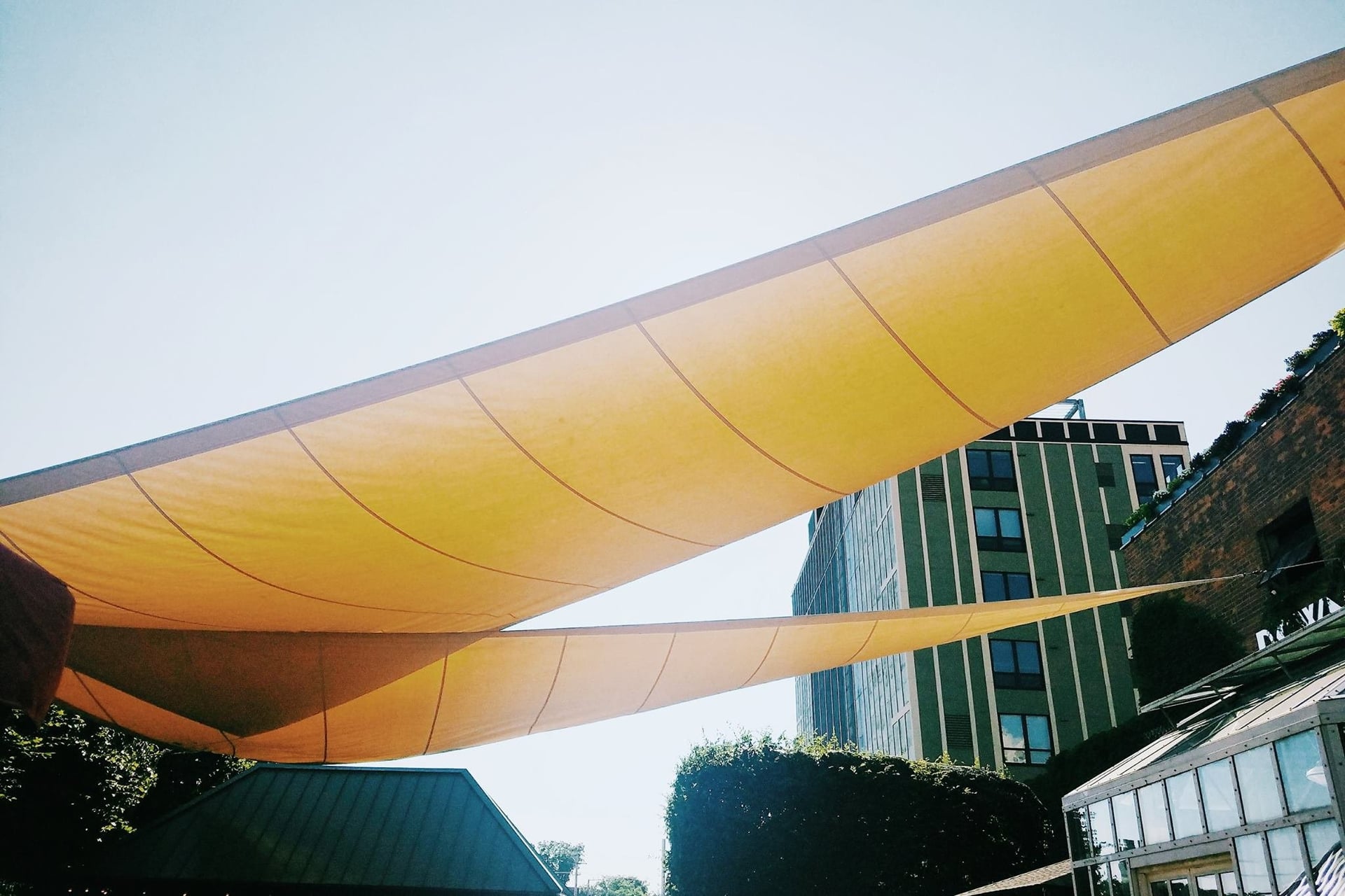 Yellow sunshade sails stretched over an outdoor area