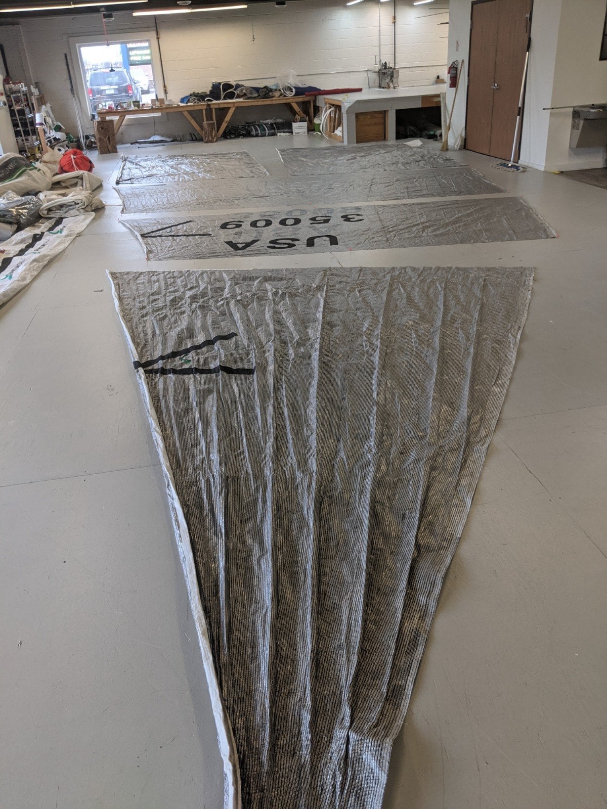 Workshop with sailcloth laid out, marked USA 35009