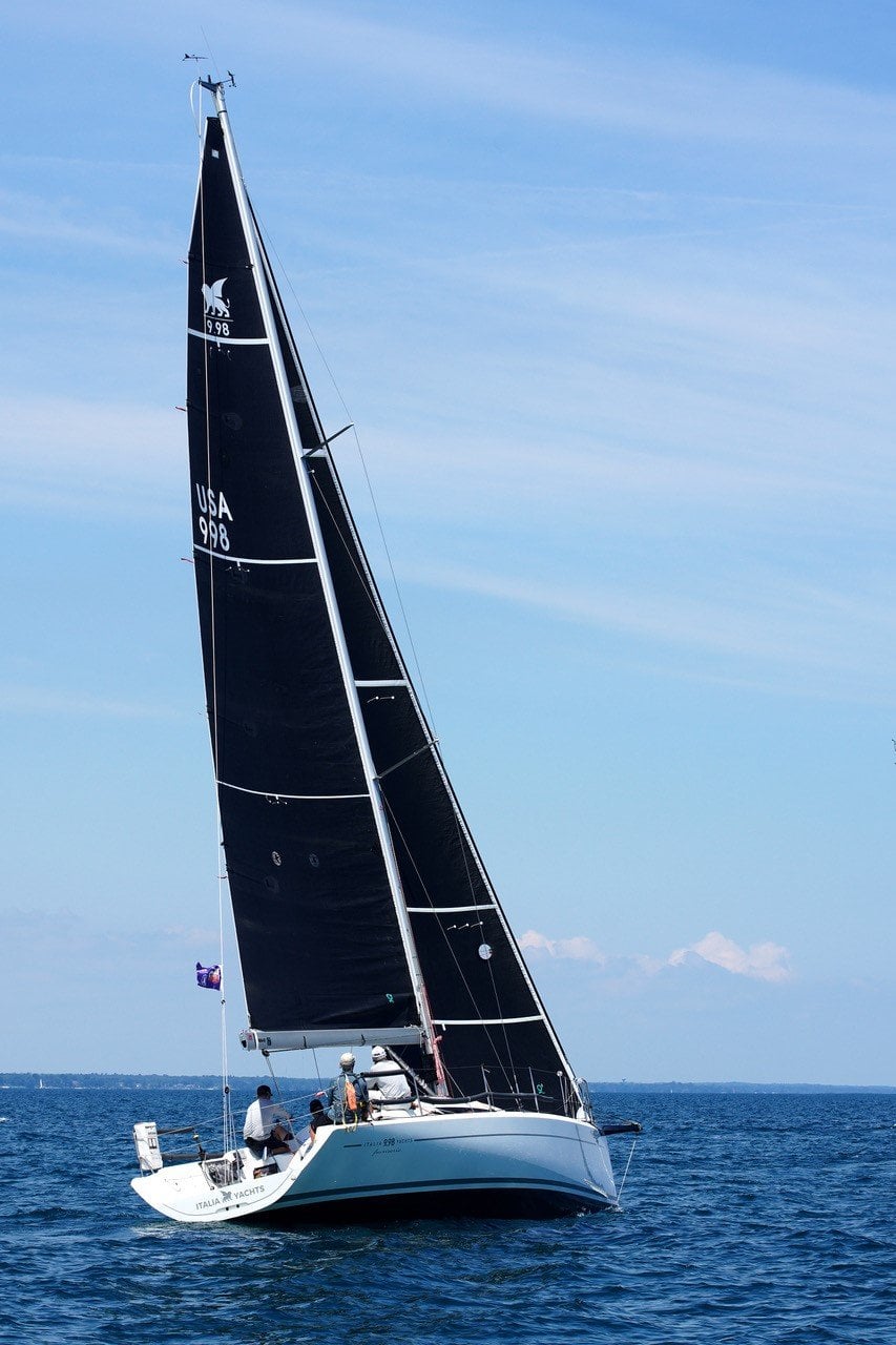 Sailboat with black sails labeled USA 998