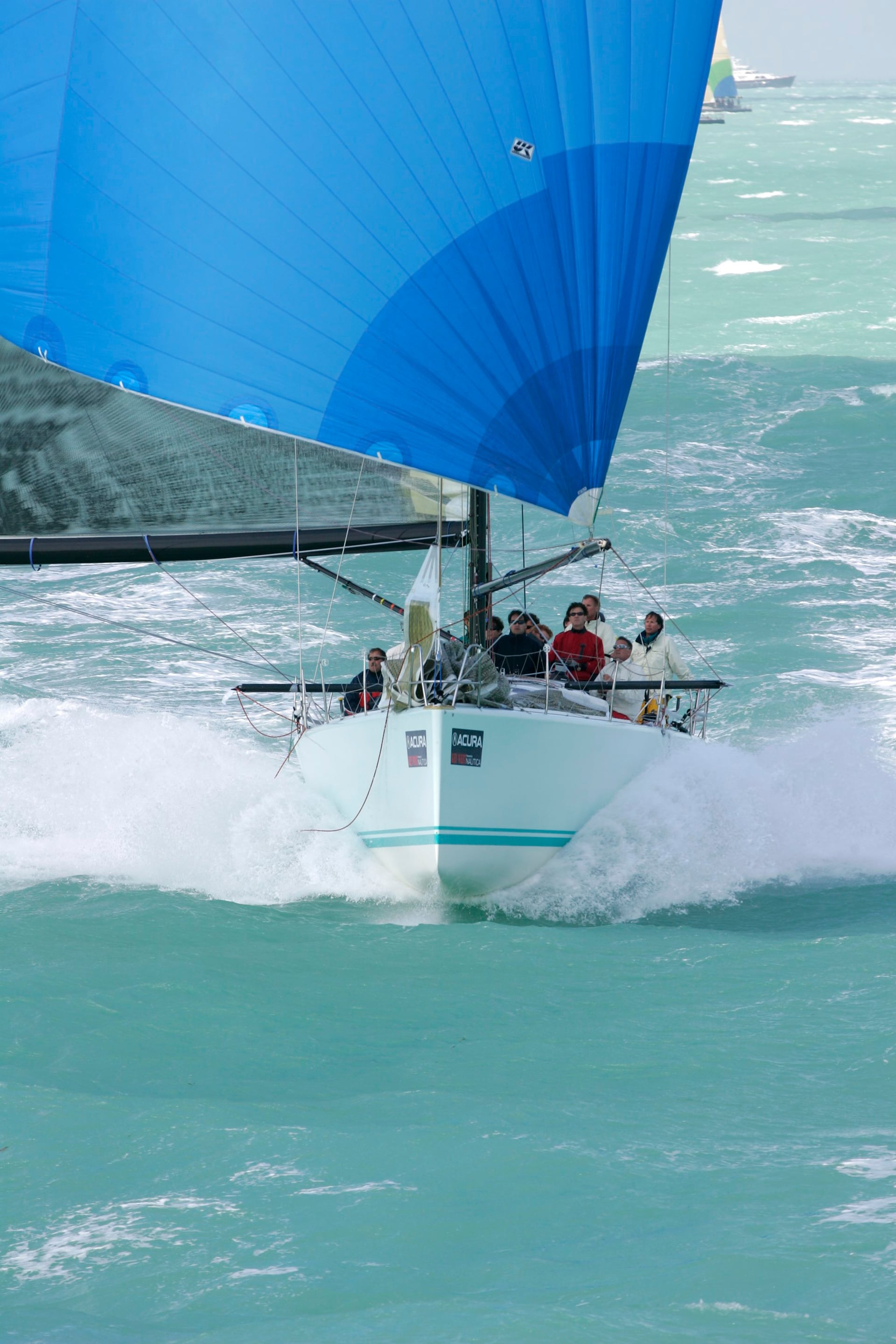 Sailboat with a blue spinnaker racing on the ocean