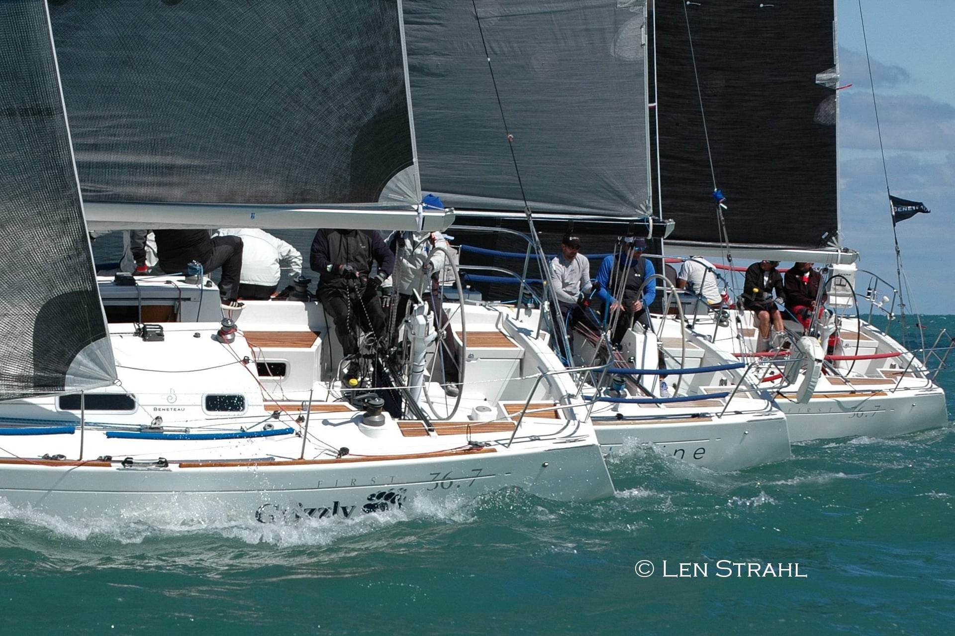 Sailboats racing with crew managing sails