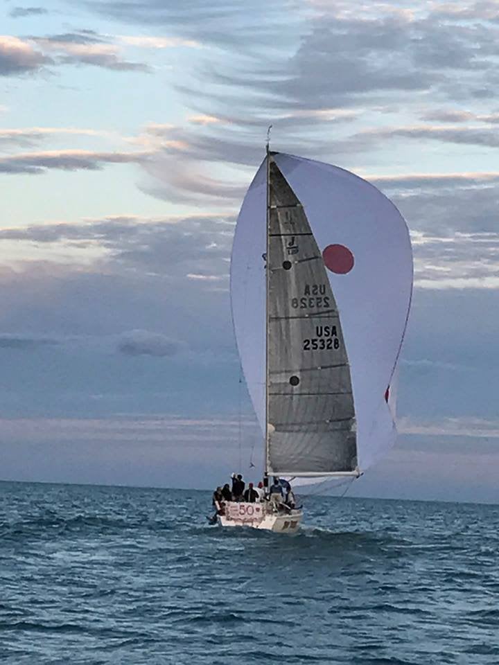 Sailboat with a large sail on open water