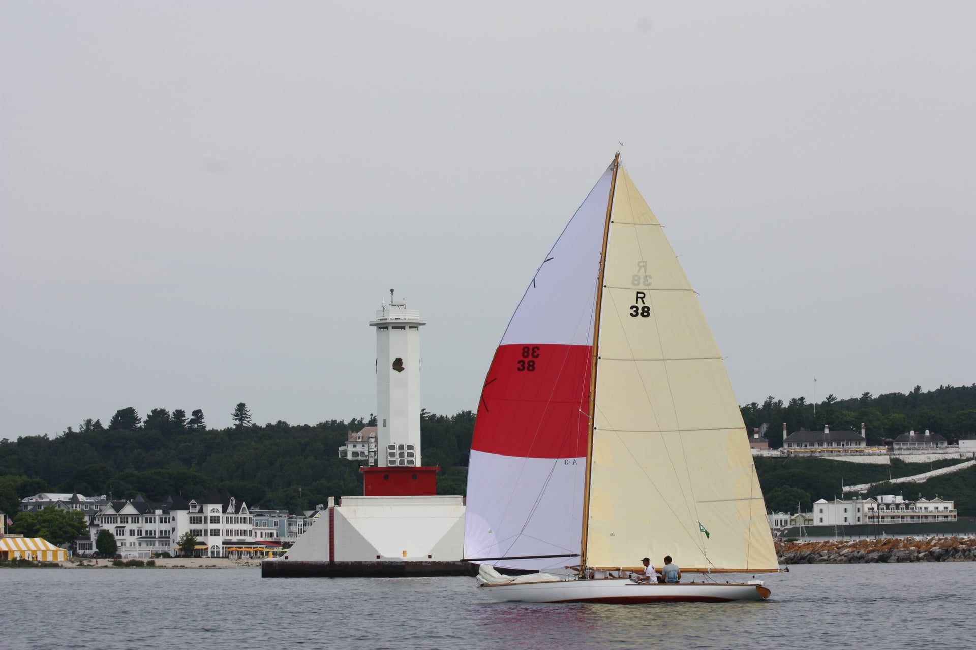 Sailboat and lighthouse near shore