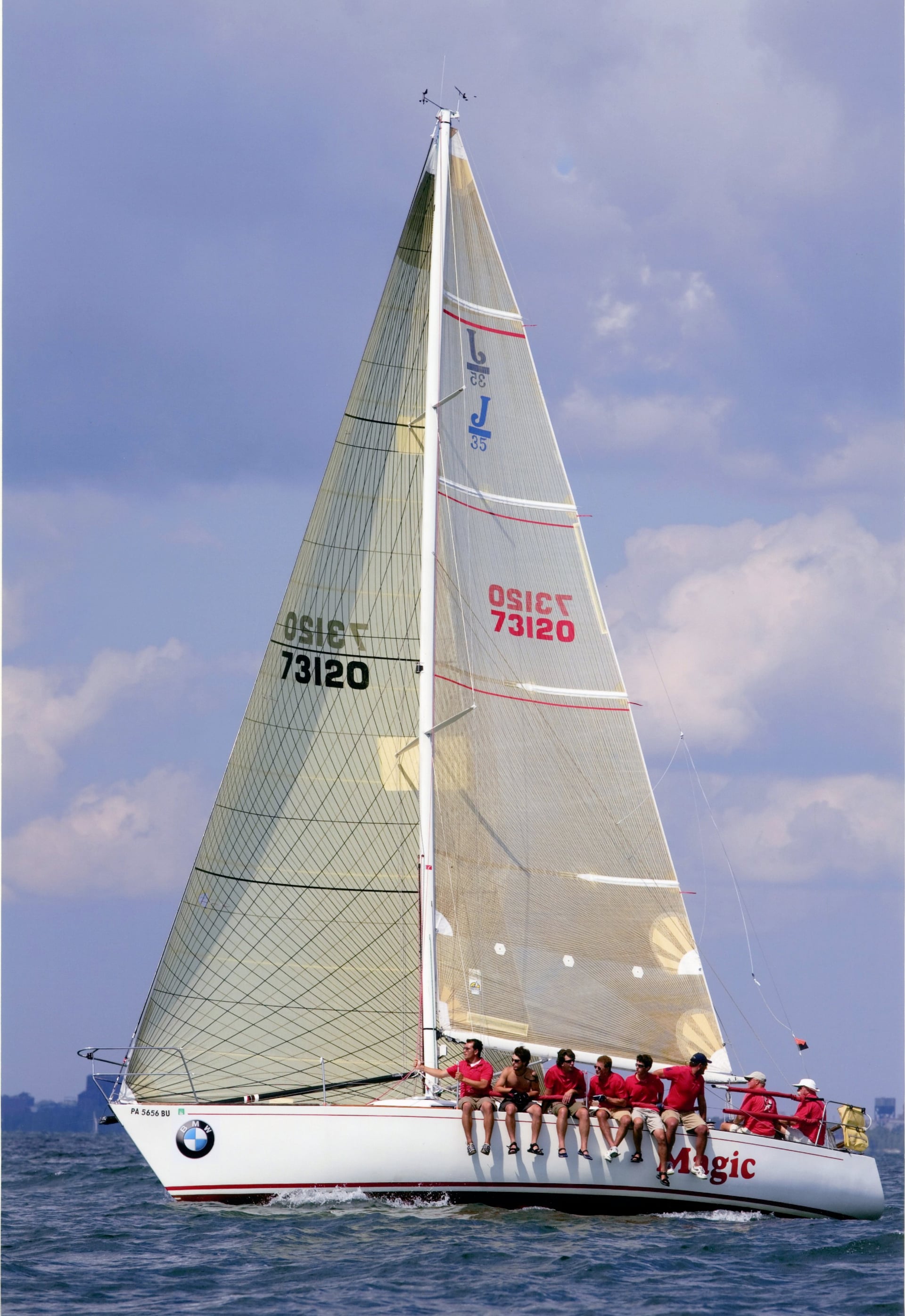 Sailing yacht with crew in red shirts